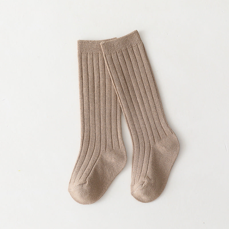 Pair of beige/tan mid-calf ribbed baby socks.