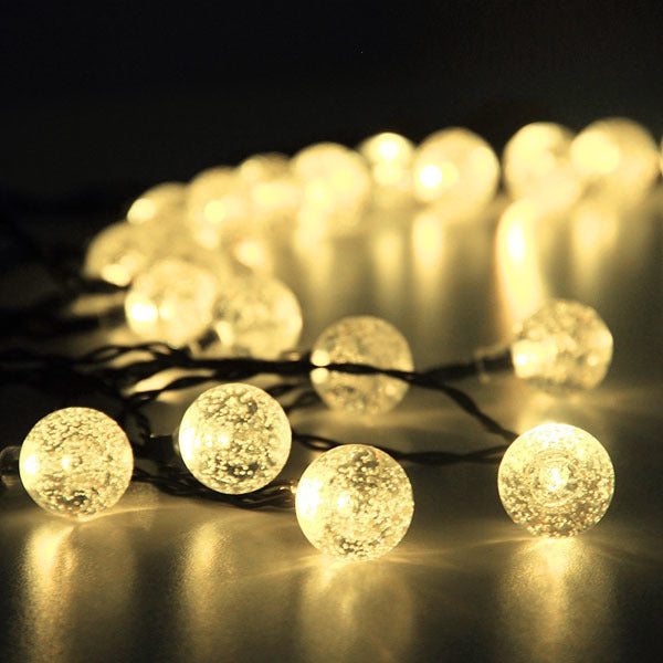 Outdoor solar fairy light string with round globe bulbs, warm white close-up