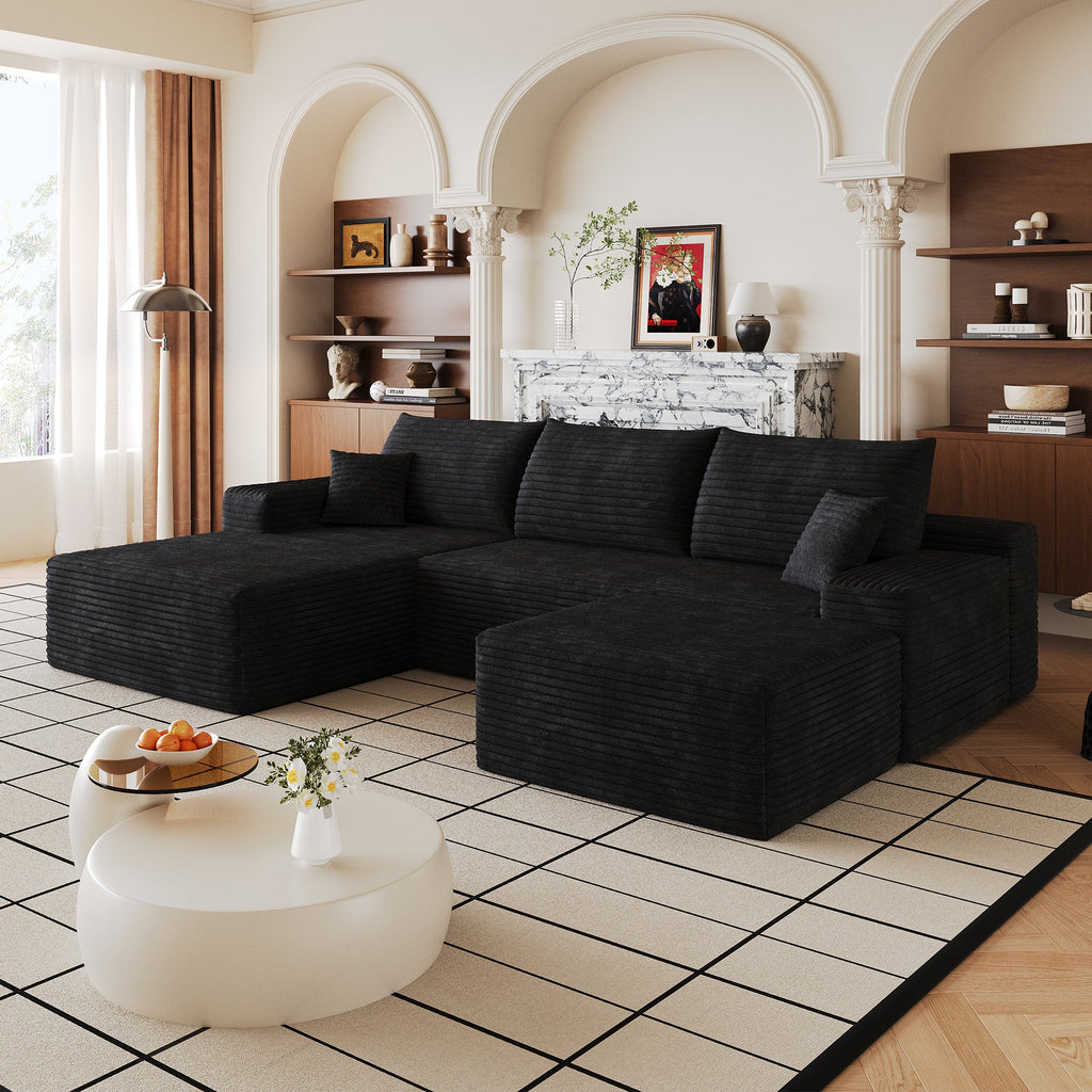Black U-shaped sectional sofa with chaise and throw pillows, plus ottoman