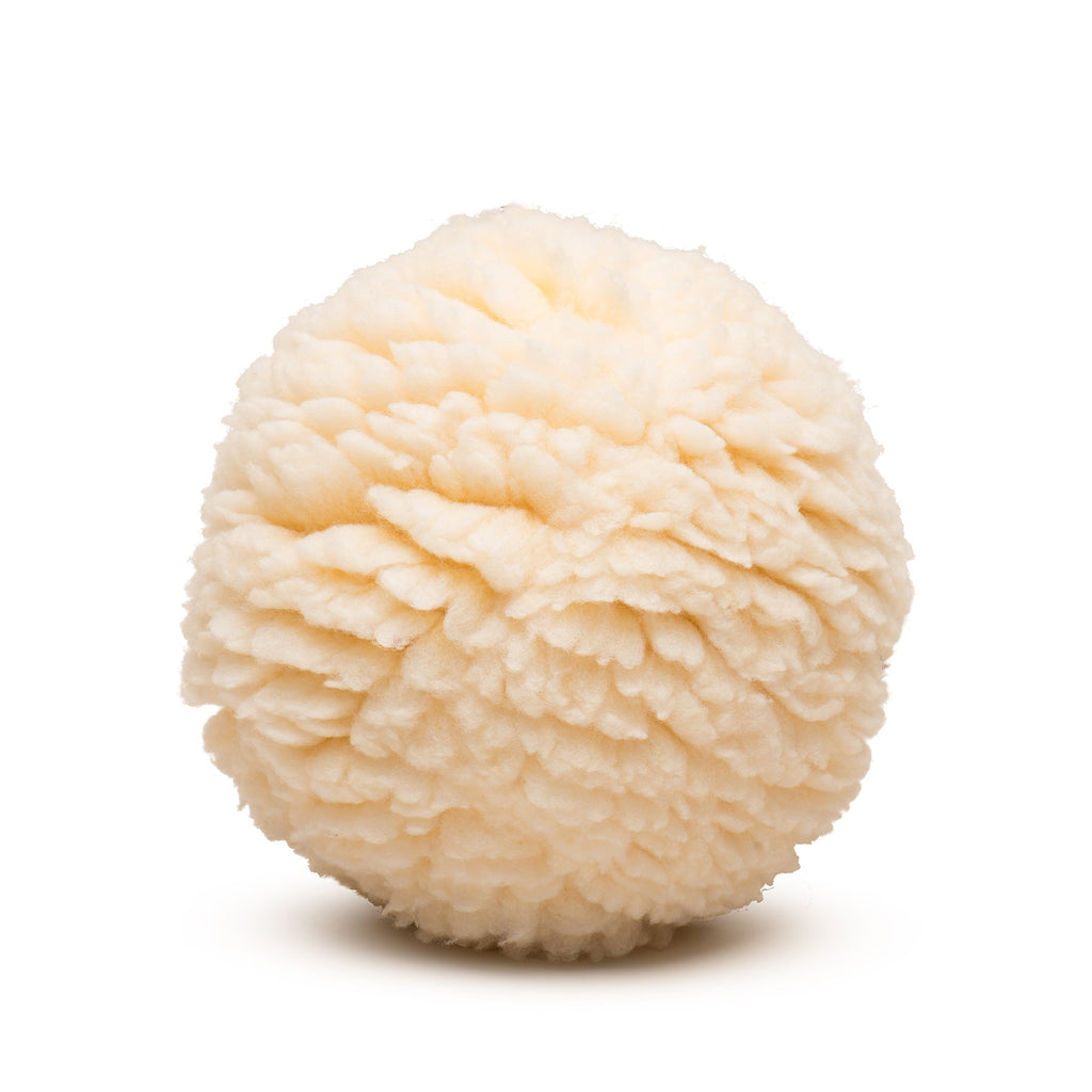 Cream fuzzy plush ball dog toy with round shape and raised fabric texture