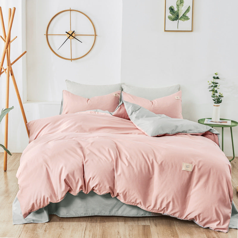 Light pink and dark gray bedding set with matching pillowcases and duvet cover