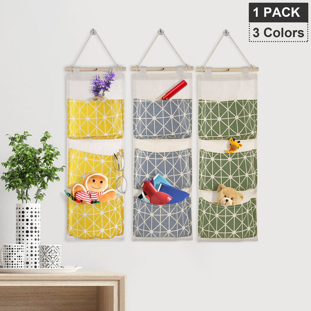 Three hanging organizer bags with three pockets each, geometric patterns and small contents
