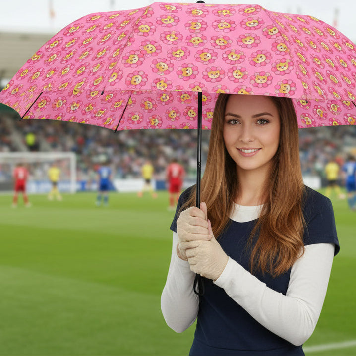 Pink compact umbrella with cat and flower pattern, open canopy on hand-held grip