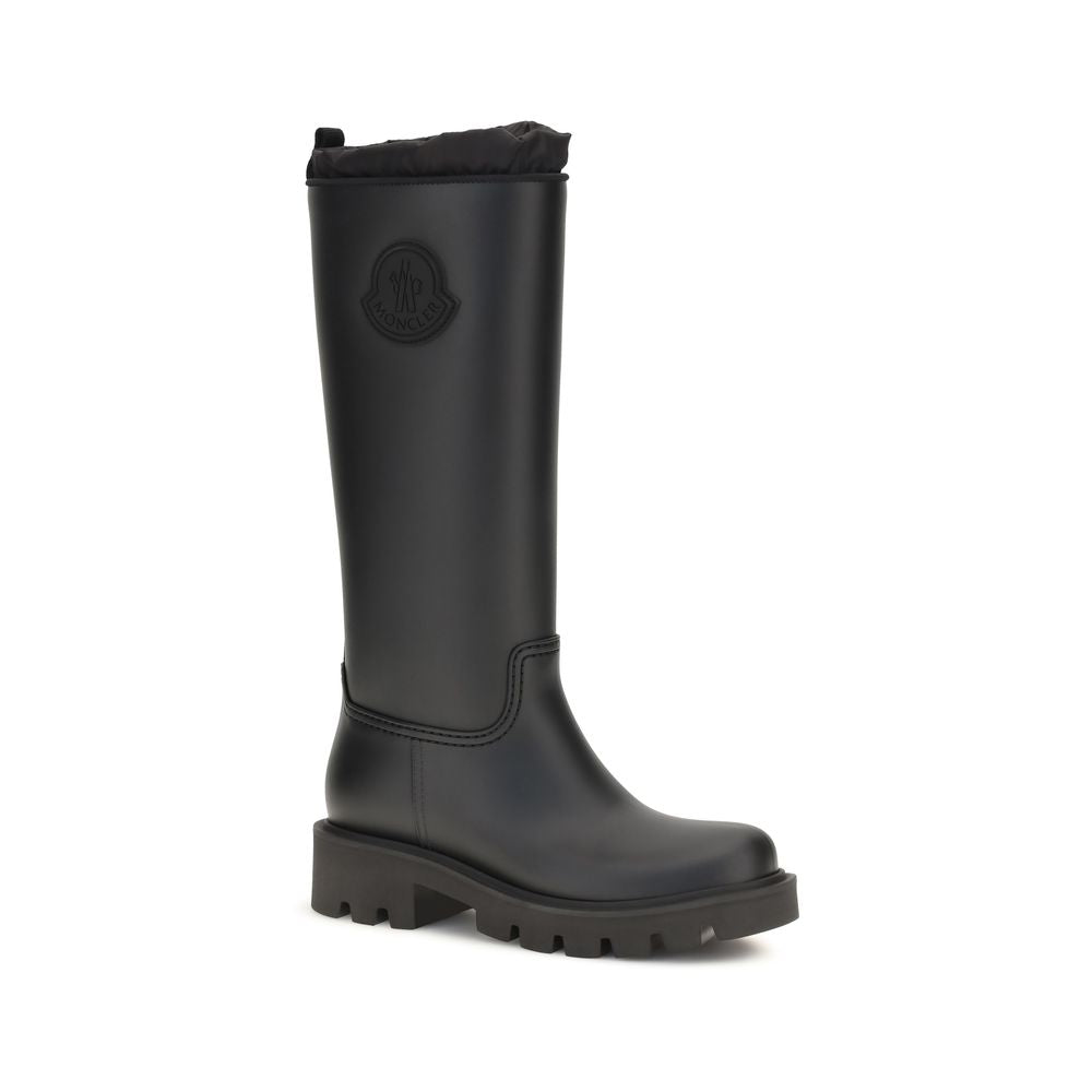 Black PVC rain boots with embossed logo patch, mid-calf pull-on, chunky treaded sole