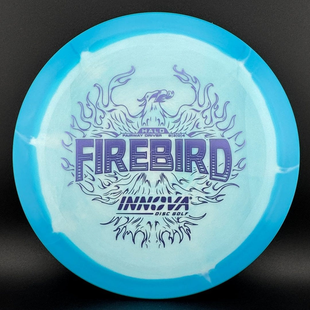 Light blue and clear disc golf disc top with fire-themed logo graphic