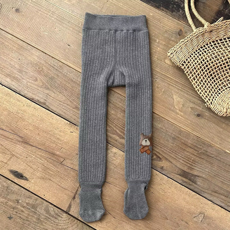Gray ribbed footed leggings with bear patch at the ankle, laid flat