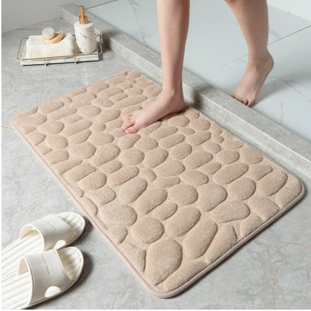 Beige bathroom bath mat with raised pebble-texture dots, non-slip backing