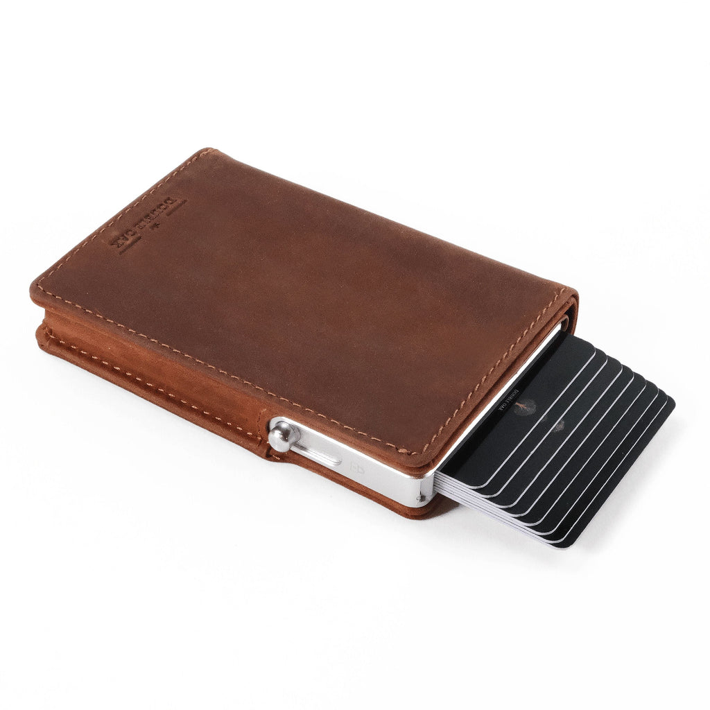 Brown leather bifold wallet open, showing card slots and back money clip.