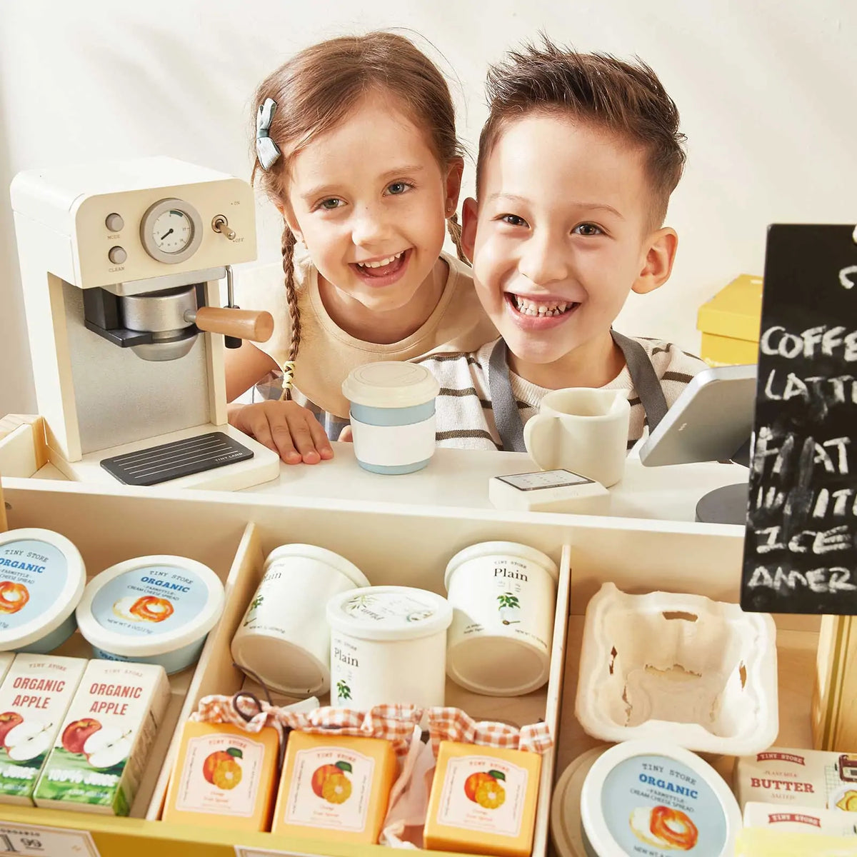 Tiny Land® kids grocery store playset with two children smiling behind the counter