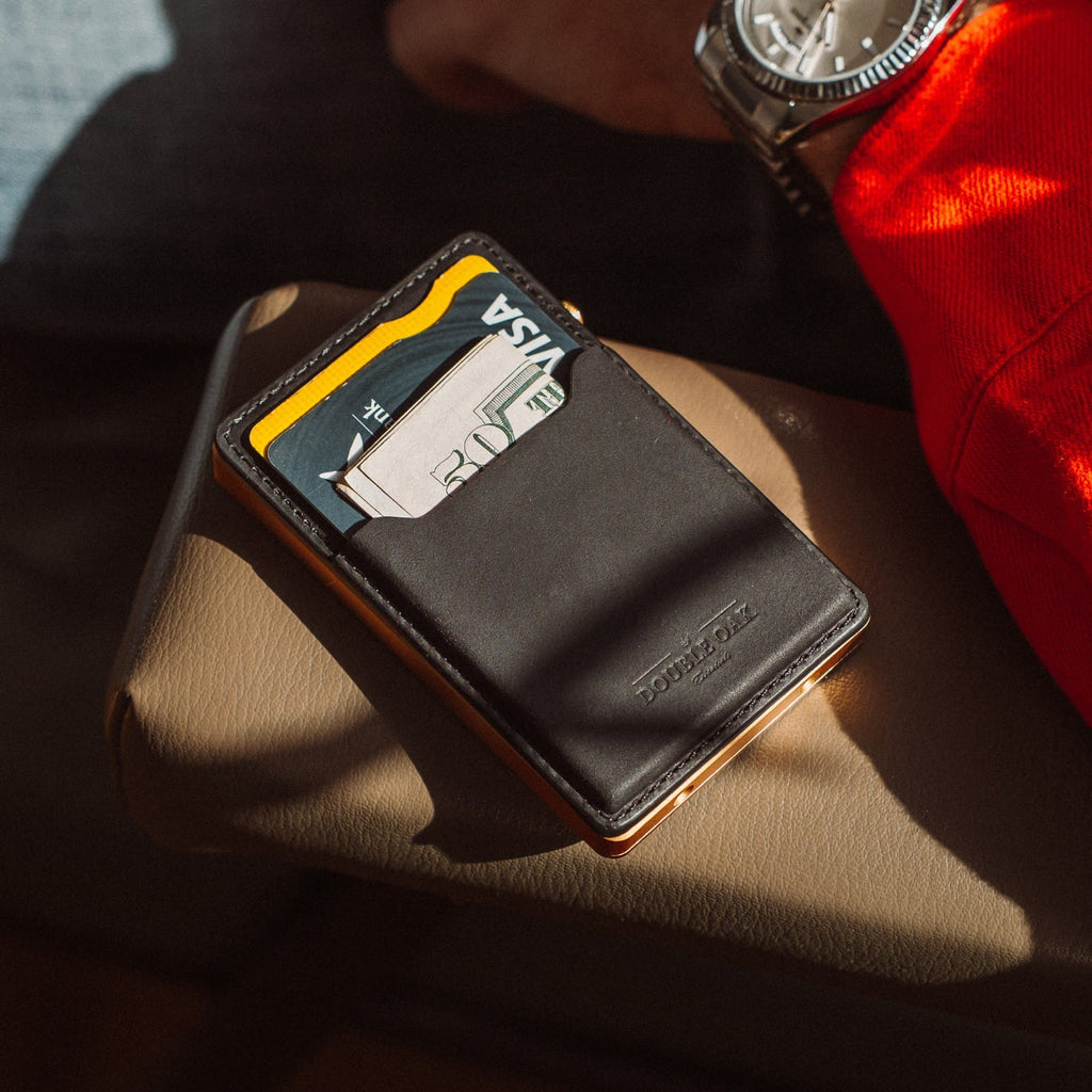 Black leather card wallet with Visa card slot and metal frame, compact carry design
