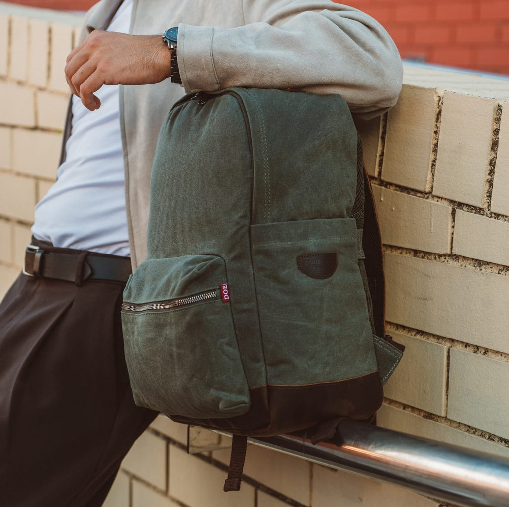 Olive green backpack with front zip pocket and side compartment