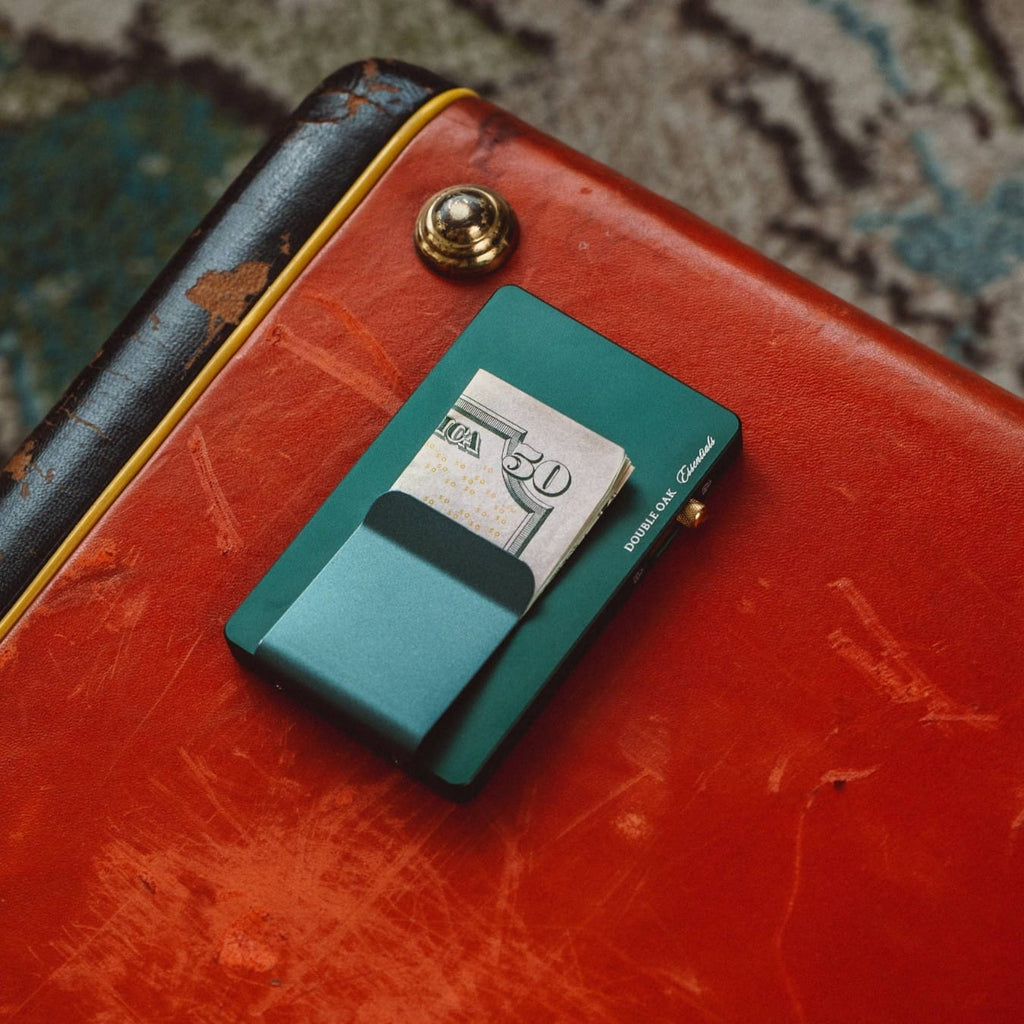 Red leather pop-up cardholder with teal exterior and a card extended