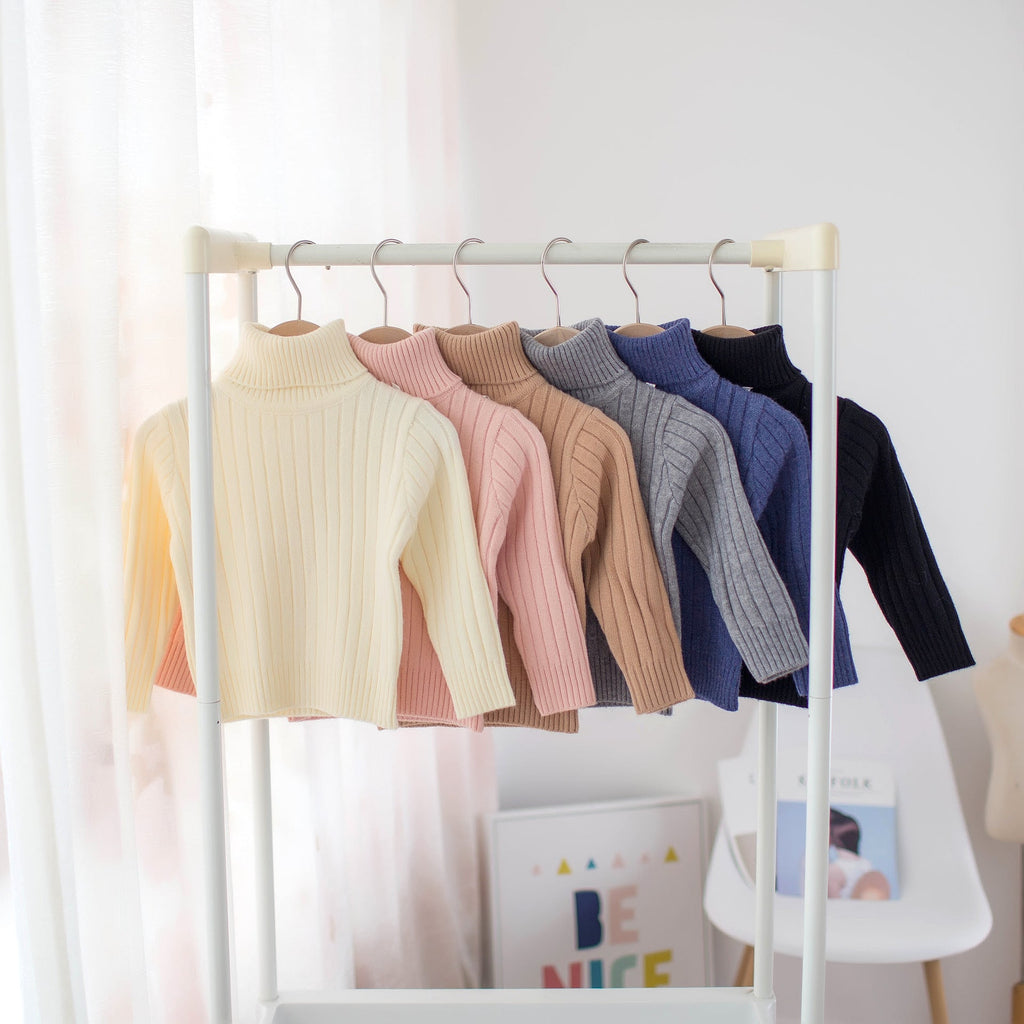 Kids ribbed turtleneck knit shirts collection on display rack