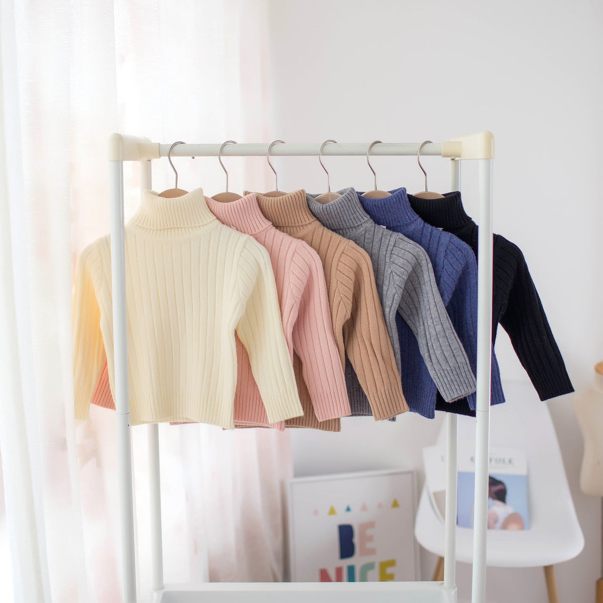 Kids ribbed turtleneck knit shirts collection on display rack