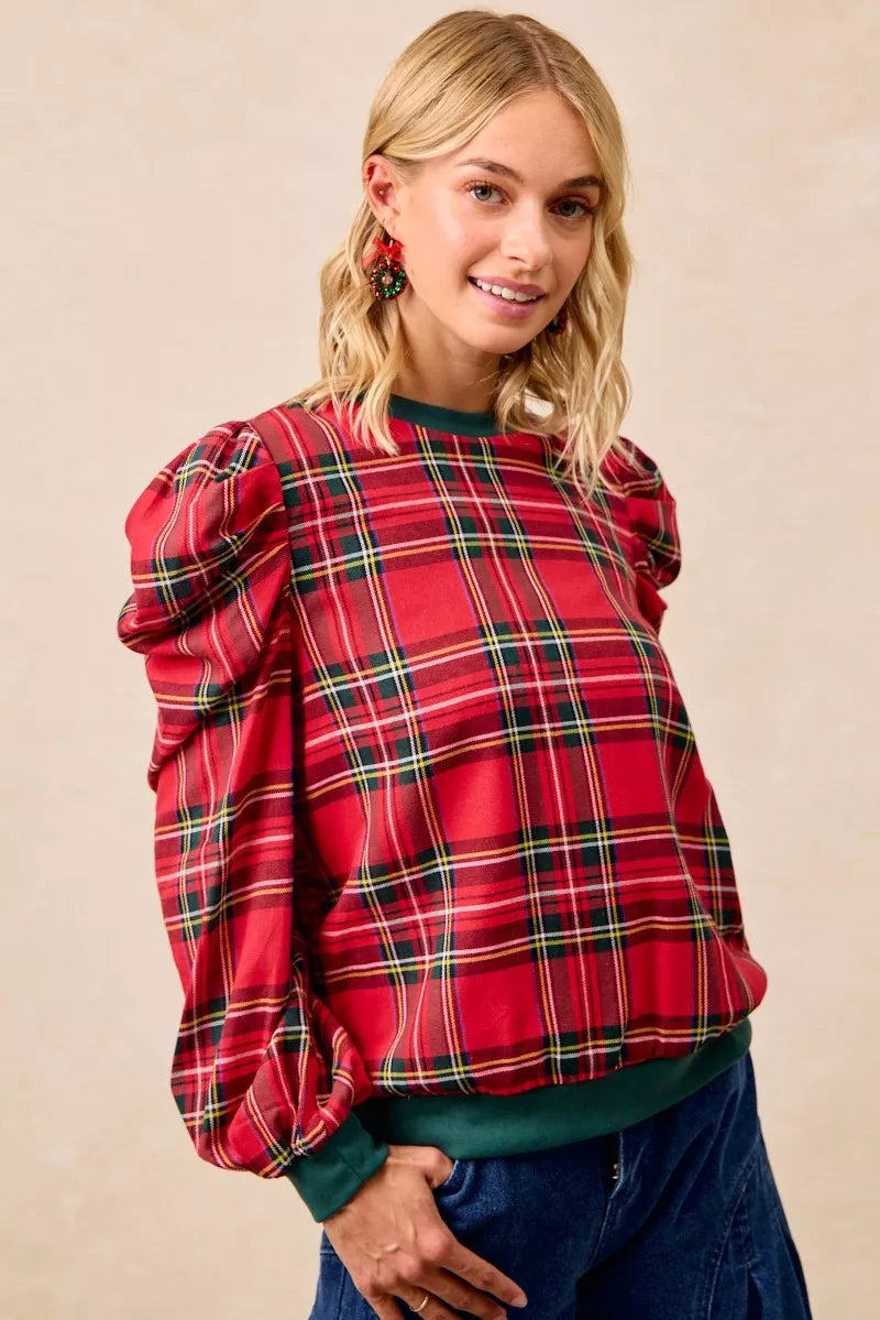 Red plaid top with exaggerated shoulder sleeves, green cuffs, and crew neckline