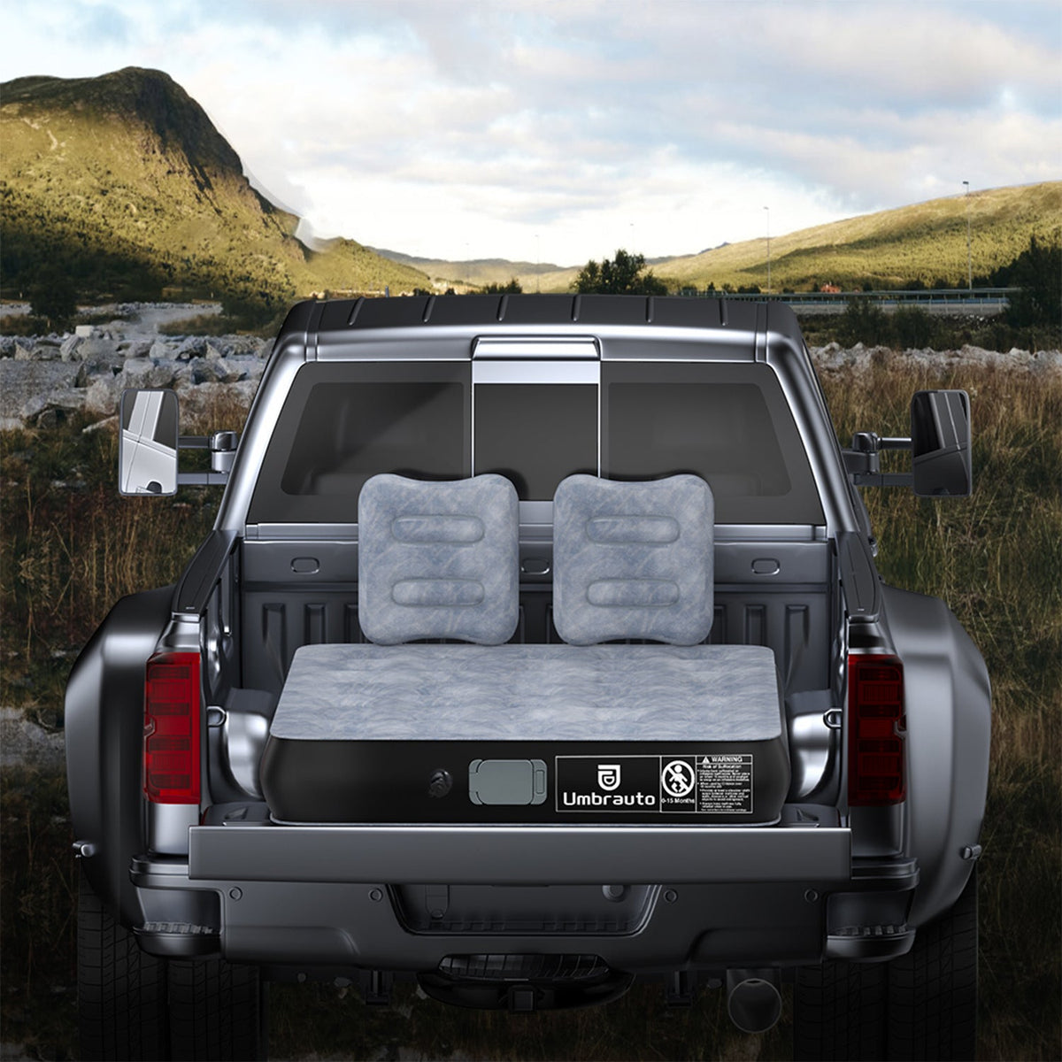 Gray inflatable pickup truck air mattress with two matching pillows in truck bed