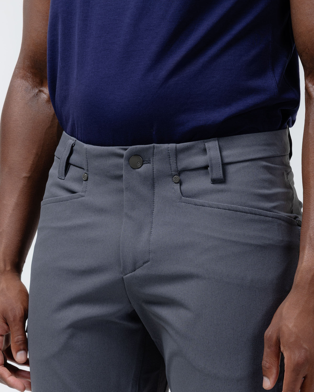 Charcoal chino pants front detail showing button closure, belt loop, and slanted pockets