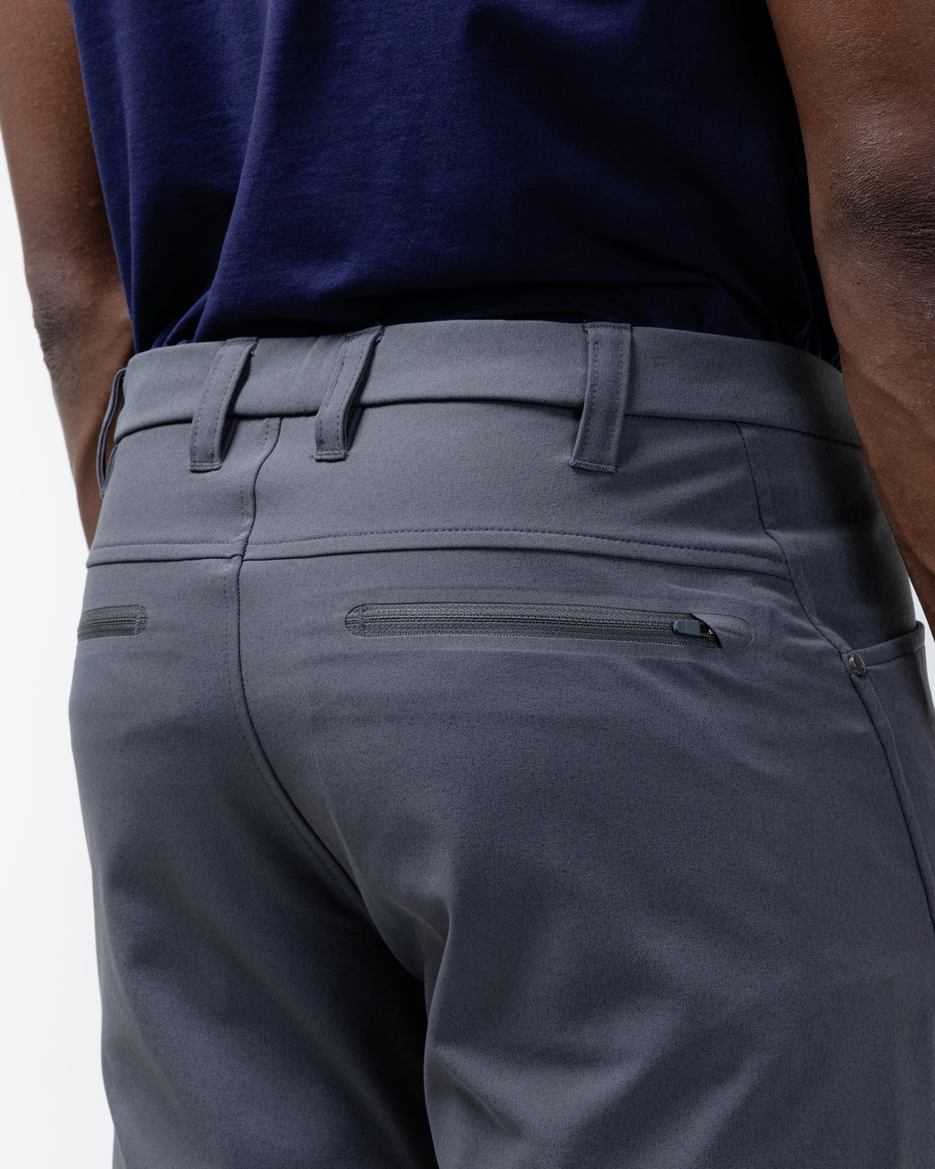 Charcoal chino pants waistband detail with belt loops, zip fly, and front pocket seam