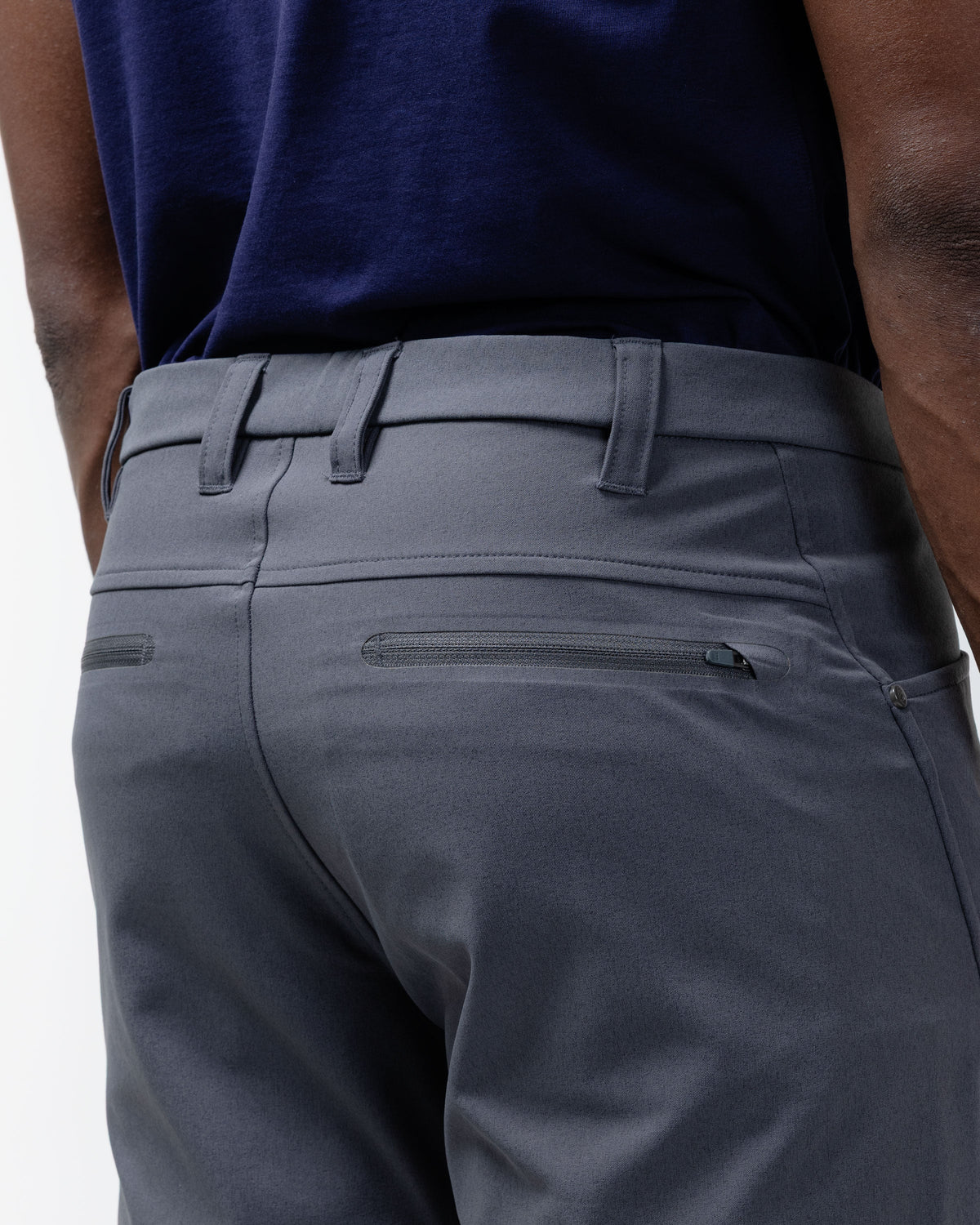 Charcoal chino pants waistband detail with belt loops, zip fly, and front pocket seam