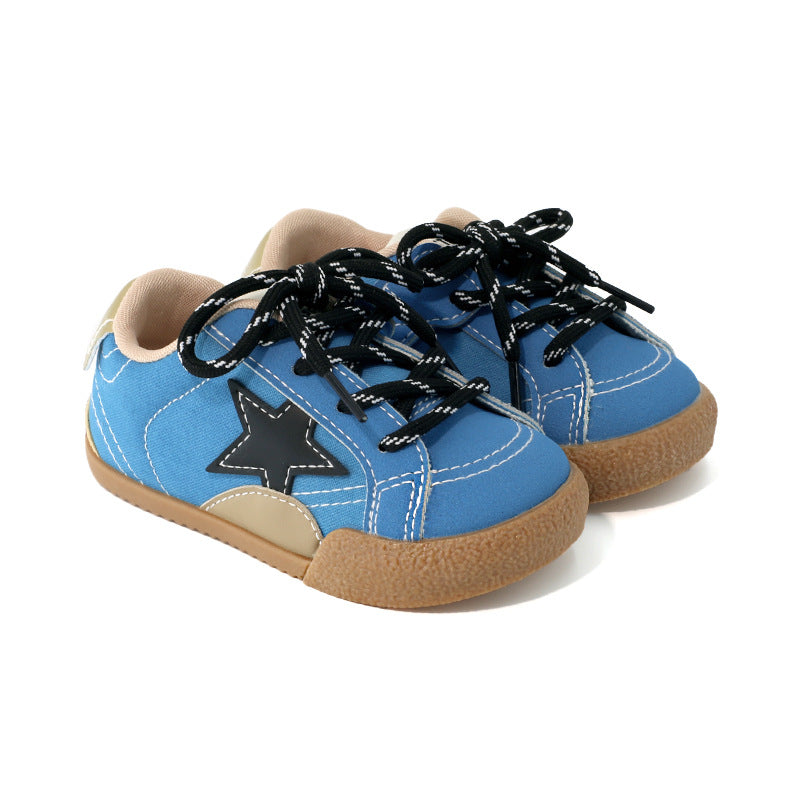 Girls sneakers in bright blue with black laces, star patch, and tan sole