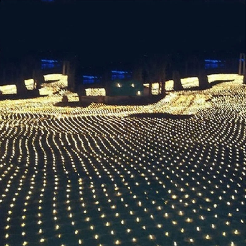 Warm white LED fishnet string lights covering a walkway and yard in a wave pattern