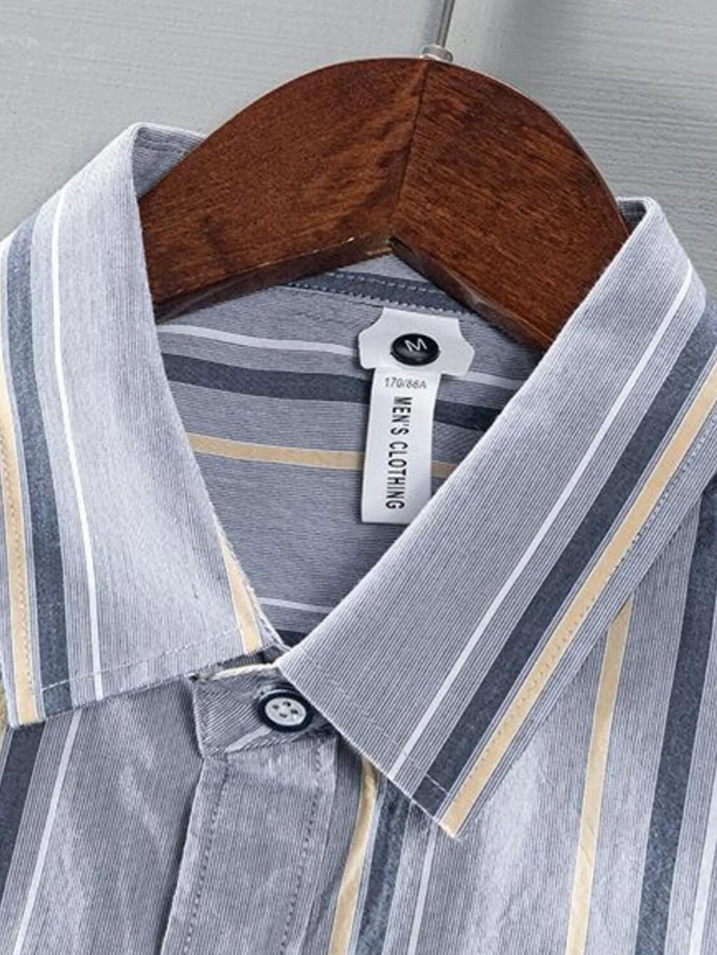 Light gray striped button-up shirt neckline with inner tag visible at collar.