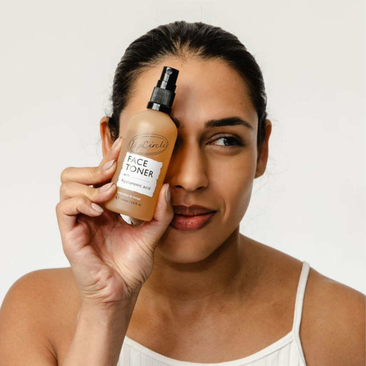 UpCircle face toner bottle held up by a person