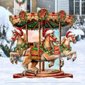 Christmas carousel outdoor decor with three painted carousel horses and festive holiday garland