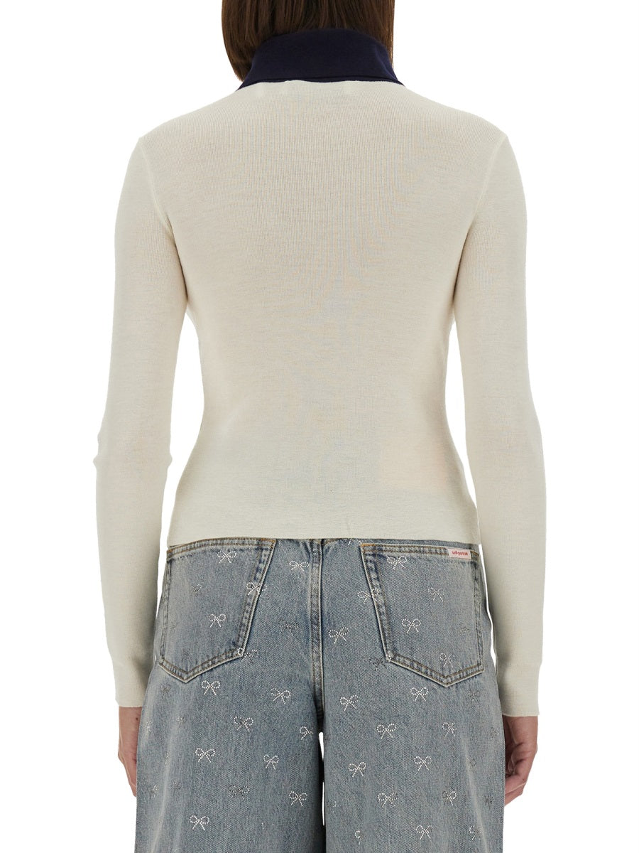 Cream merino wool cardigan back view with long sleeves and navy contrast collar