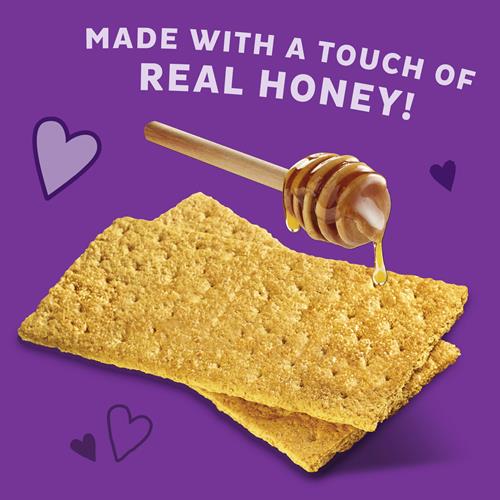 Annie's Organic Honey Graham Crackers with honey drizzle and cracker pieces shown.