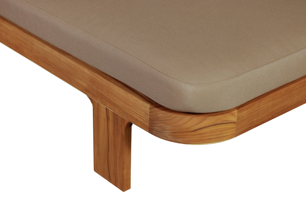 Outdoor teak wood sun lounger armrest detail with light brown cushion