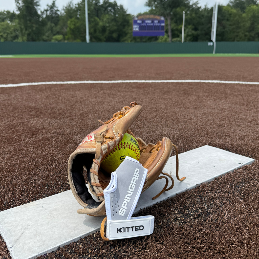 Gray and neon green softball glove on field, leather pocket and laced web