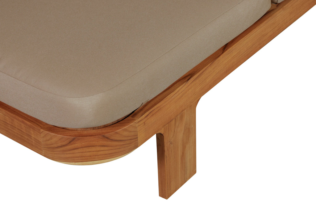 Outdoor teak wood sun lounger leg and cushion edge with light brown fabric