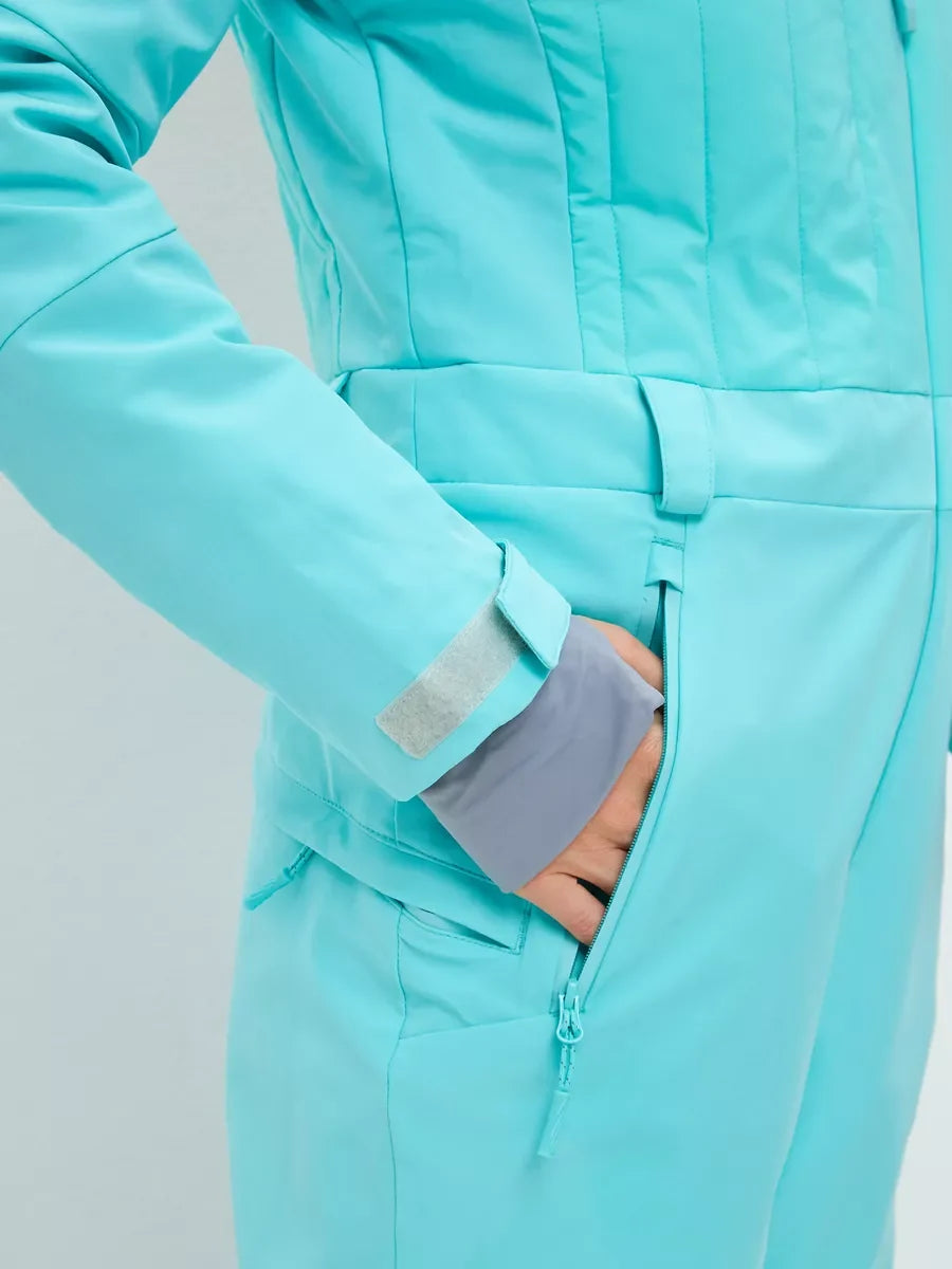 Mint ski jumpsuit front view of hidden zip, waist belt, and cuff seam detail