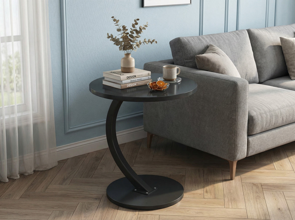 Dark round side table with curved base and lower shelf, black finish.