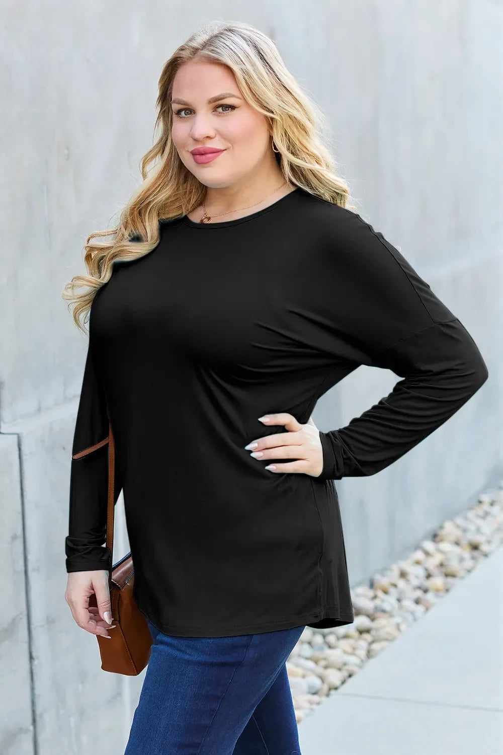 Black relaxed long sleeve crewneck tee with long sleeves and curved hem