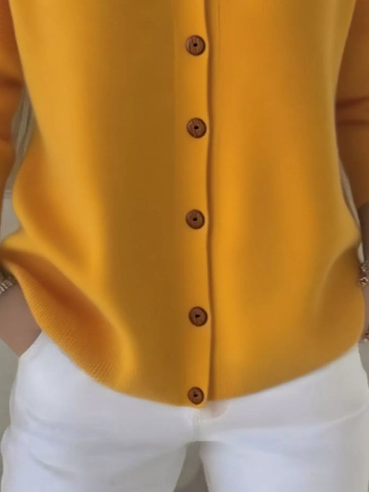 Mustard yellow hooded knit cardigan front with vertical button placket