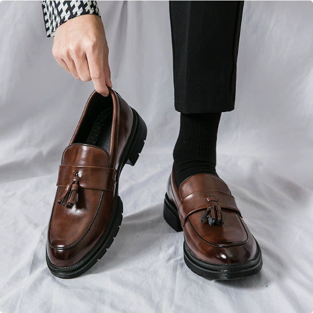Brown leather tassel loafers with slip-on design and dark rubber sole
