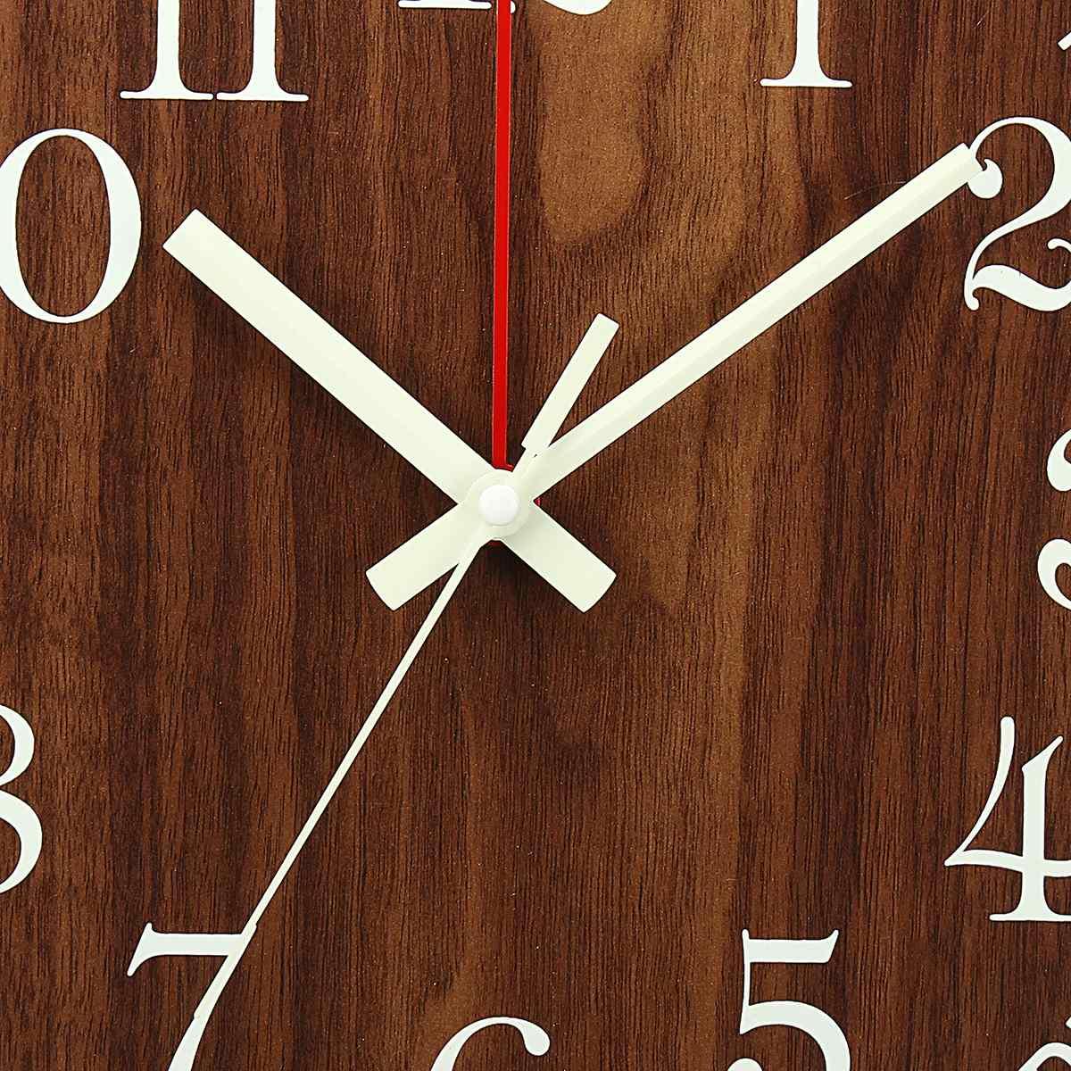 Wooden wall clock close-up of white minute and hour hands with red center divider