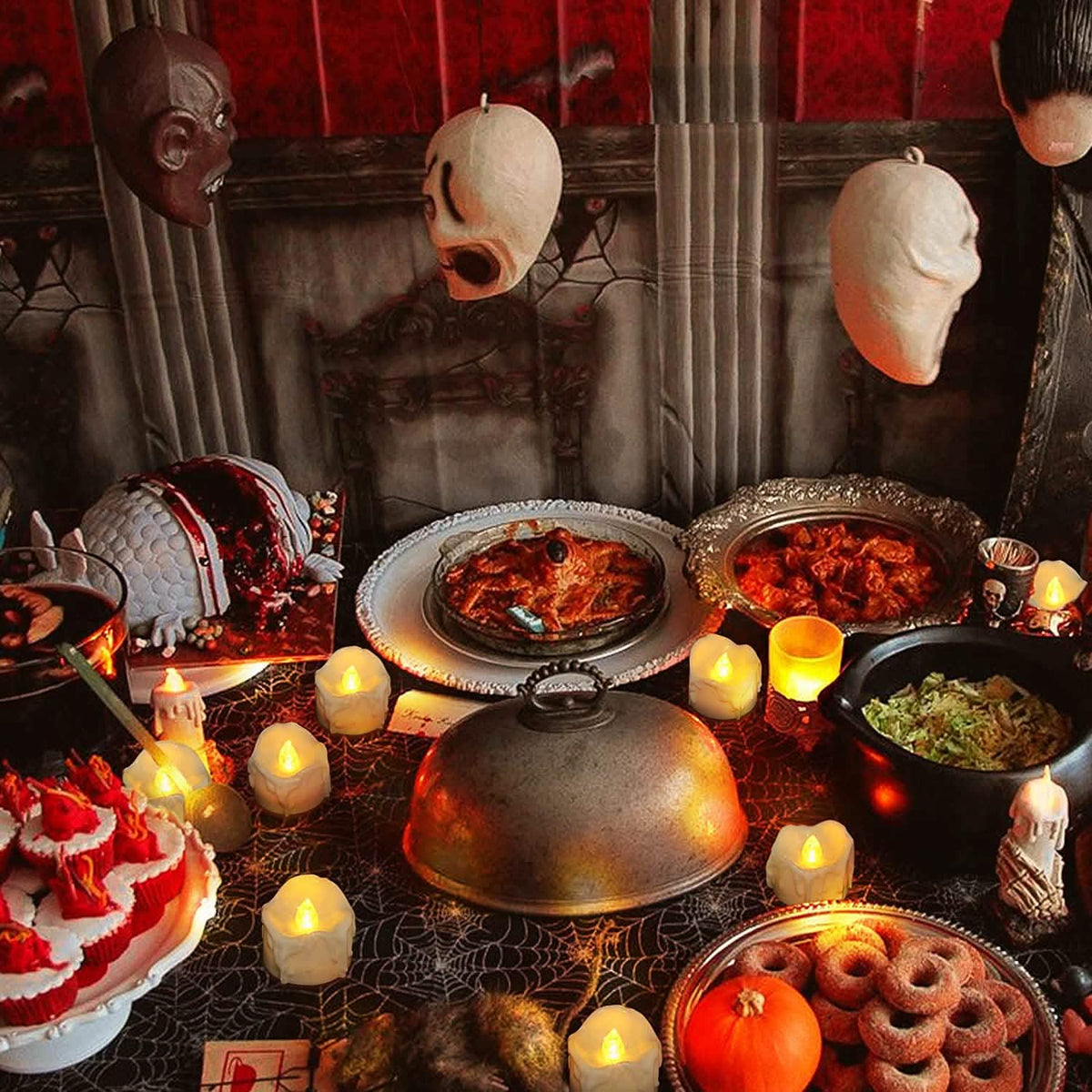 White LED candles with glowing flames among Halloween table decor