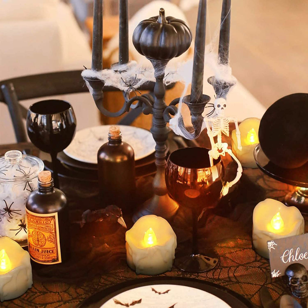 White LED candles with glowing flames on a table centerpiece