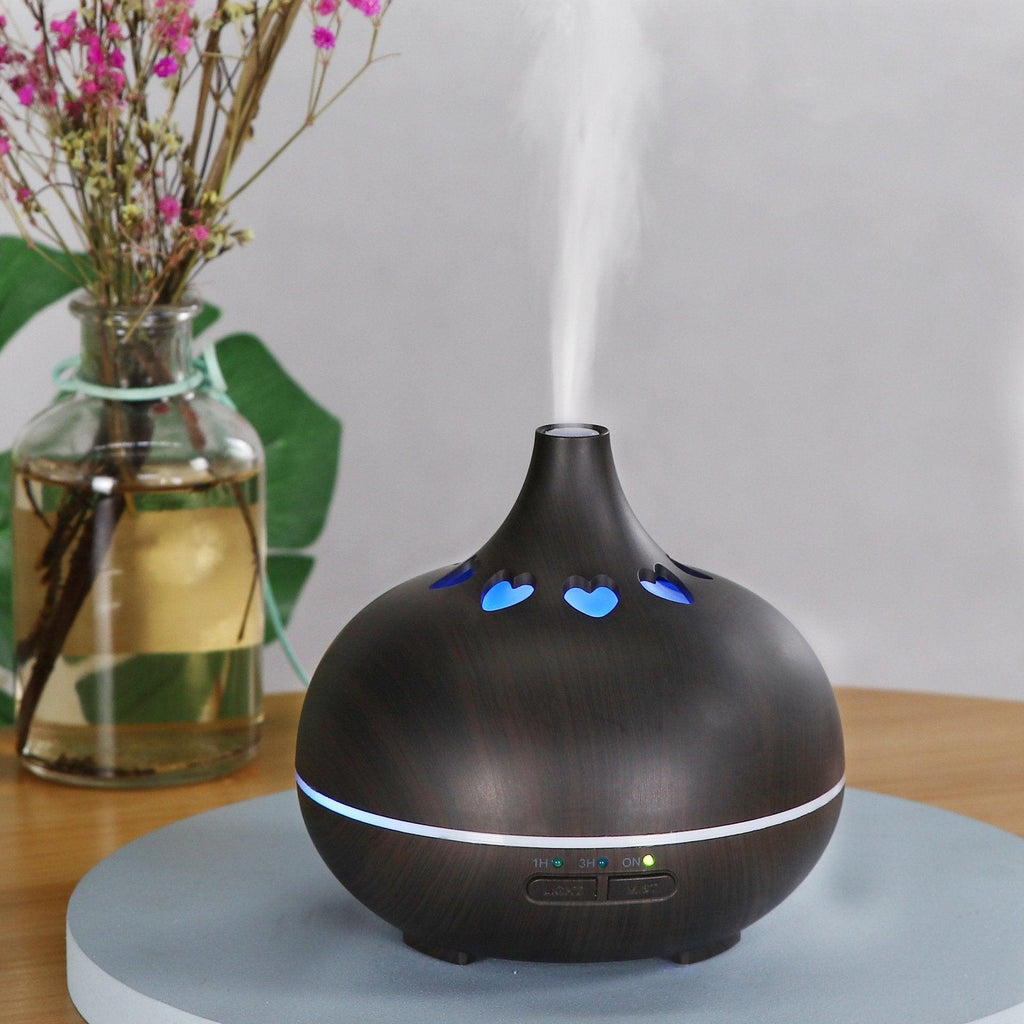 Black aromatherapy diffuser with blue heart LED lights and cool mist