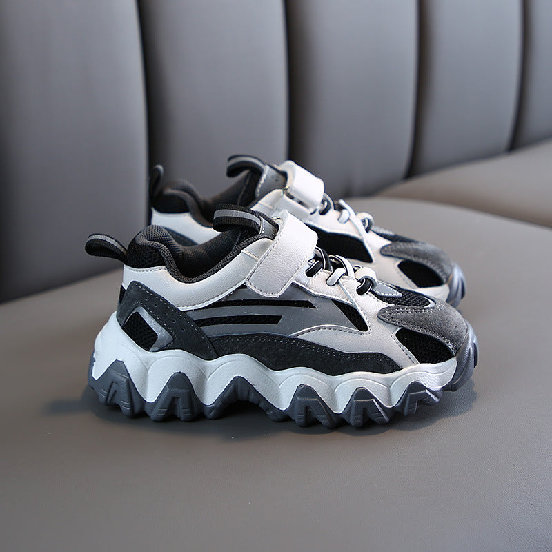 Chunky velcro sneakers in white and black with hook-and-loop straps and textured tread
