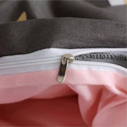 Pink and gray bedding cover with visible zipper closure
