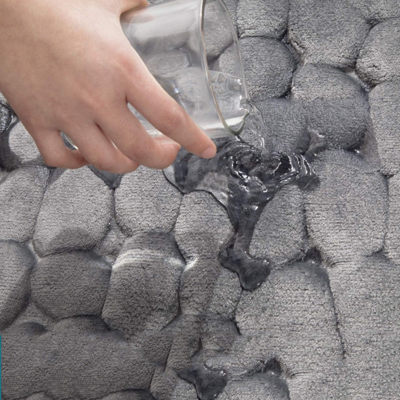 Close-up of gray bathroom bath mat’s raised pebble texture and non-slip grip