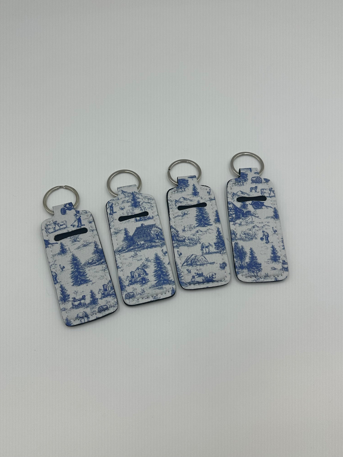 Chapstick holder keychain set with blue mountain scenic designs, metal rings