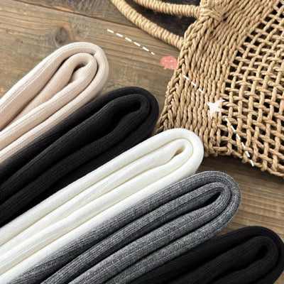 Assorted color folded footed leggings: black, cream, light gray, and dark gray