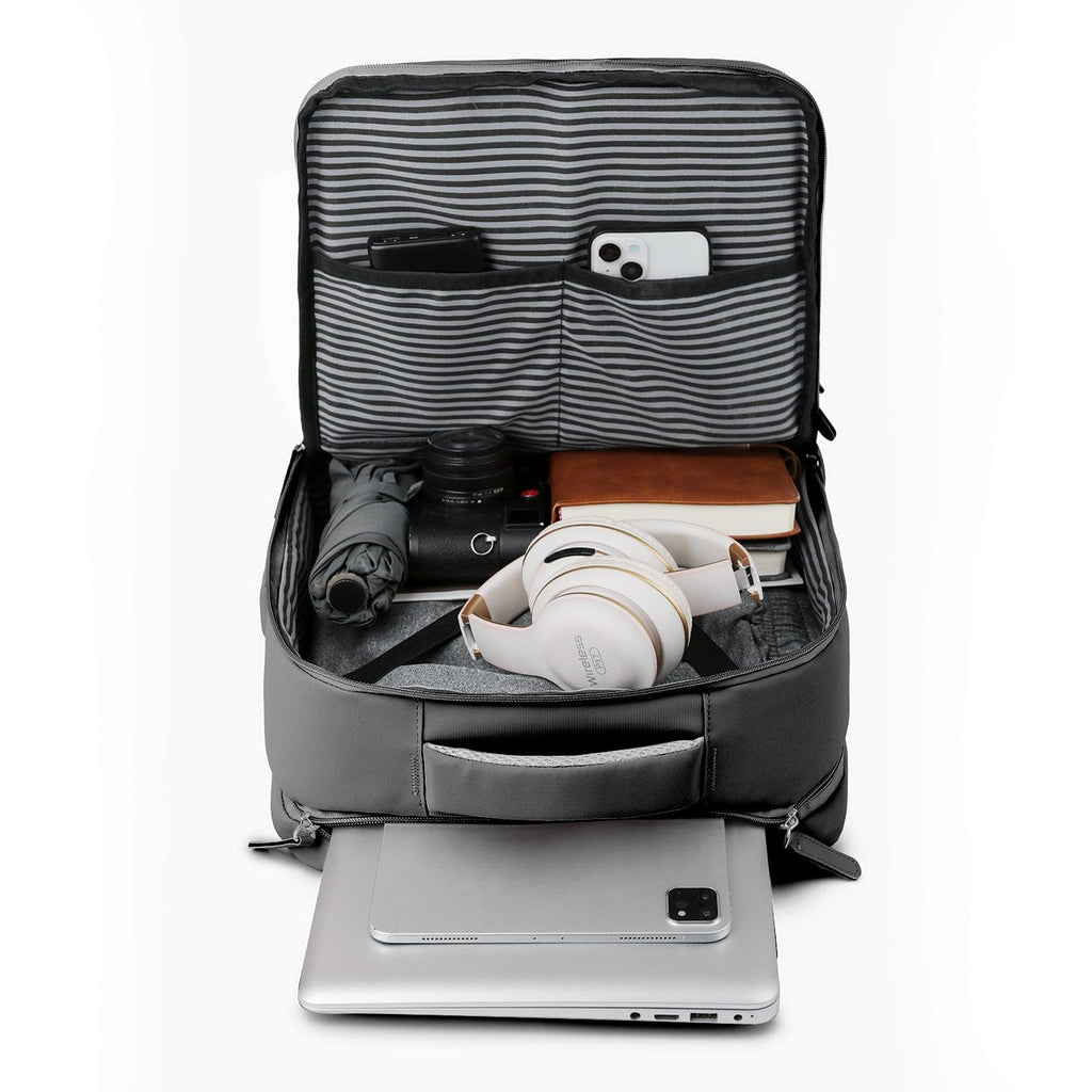 Black backpack open with striped organizer pouch and zippered device sleeves.
