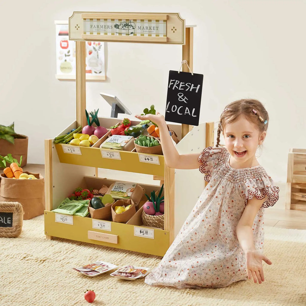 Tiny Land® kids grocery store playset with produce bins and child reaching for items