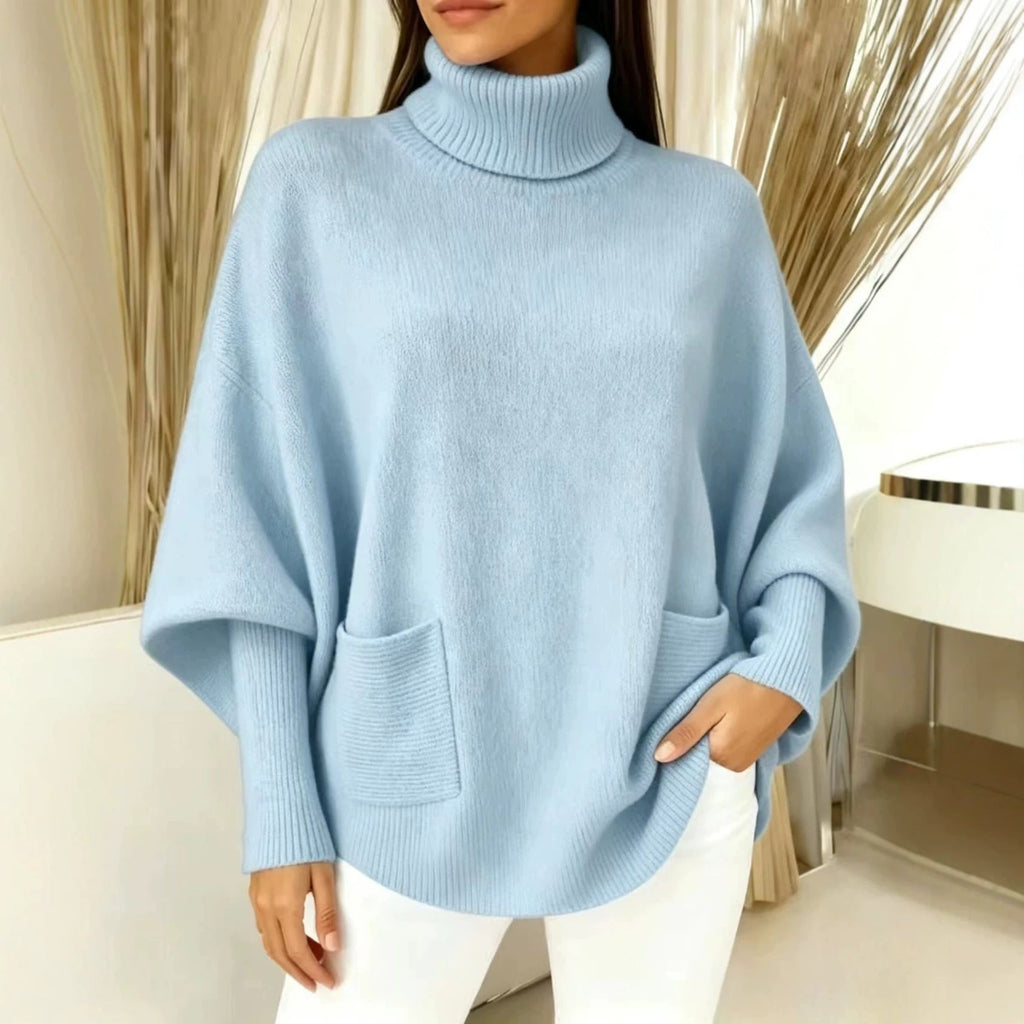 Light blue women’s turtleneck sweater with long sleeves and front patch pocket
